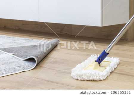 Wooden floor with white mop, cleaning service concept Wooden floor with white mop, cleaning service concept 106365351