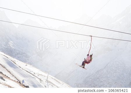 People are lifting on open lft high up in Caucasus mountains People are lifting on open lft high up in Caucasus mountains 106365421