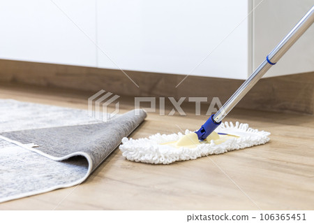 Wooden floor with white mop, cleaning service concept 106365451