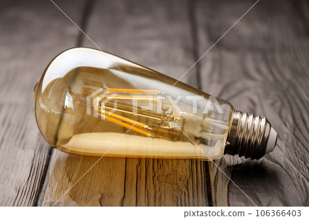 Light bulbs on dark wooden background close up Light bulbs on dark wooden background close up 106366403
