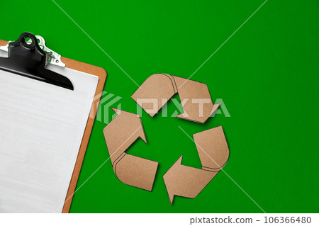 Paper recycling concept on green background top view 106366480