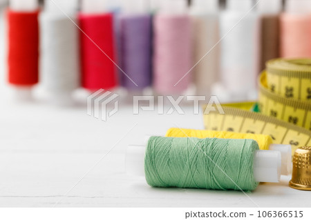 Close up of colored thread coils, thread spools background Close up of colored thread coils, thread spools background 106366515