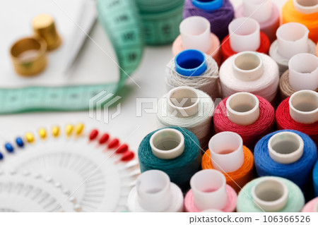 Close up of colored thread coils, thread spools background 106366526