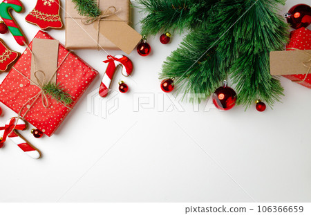 Christmas gifts with fir tree branches and decorations on white background Christmas gifts with fir tree branches and decorations on white background 106366659