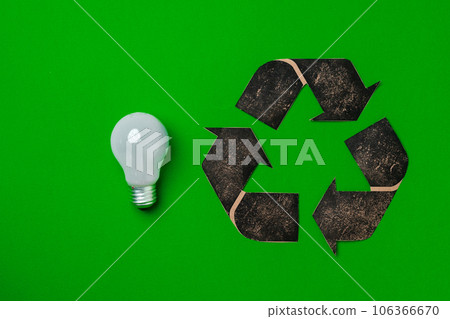 Light bulb and recycling sign on green background 106366670