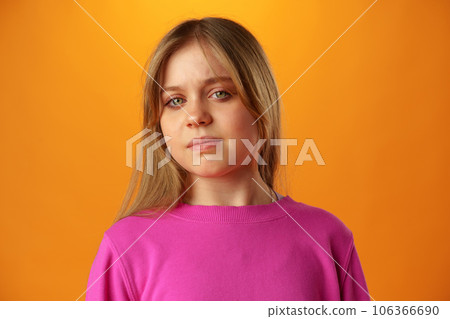 Upset disturbed teen girl on yellow background 106366690