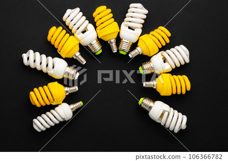White and yellow light bulbs on black background 106366782