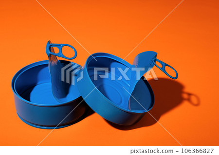 Aesthetic concept with blue painted tin can on orange background 106366827