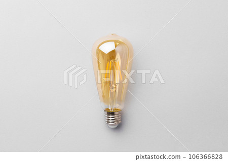 Light bulb on light grey paper background 106366828