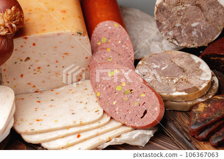 Variety of meat and sausage products on table 106367063