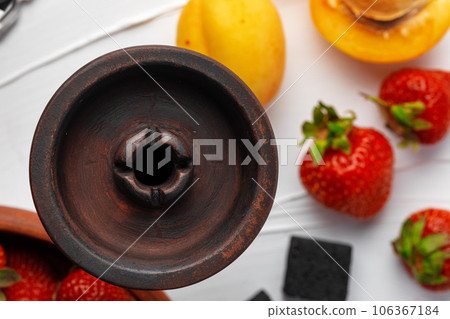 Empty hookah shaft close up on table with fresh fruit Empty hookah shaft close up on table with fresh fruit 106367184