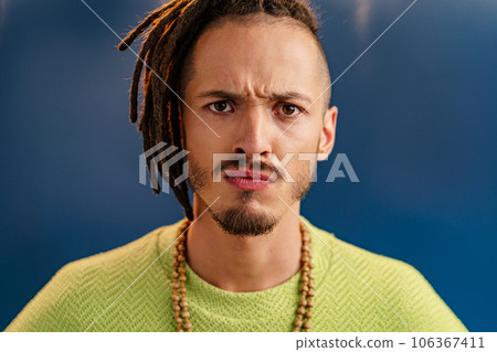 Close-up portrait of a young stylish man with dreadlocks 106367411