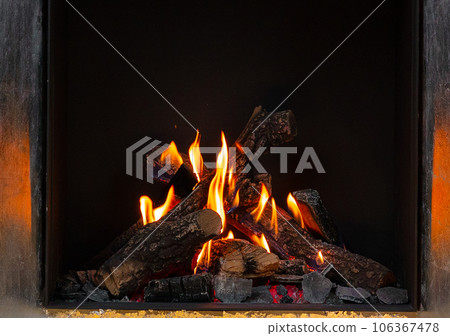 Wood logs burning in fireplace close up Wood logs burning in fireplace close up 106367478