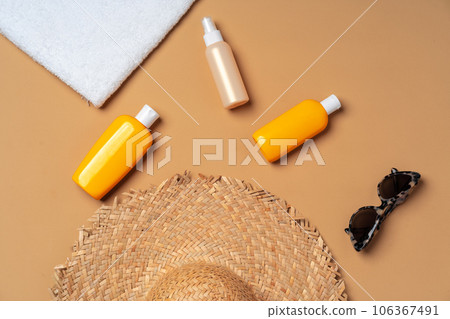 Suntan cosmetic product with towel, hat and sunglasses Suntan cosmetic product with towel, hat and sunglasses 106367491