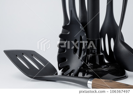 Stand with set of kitchen utensils on white background Stand with set of kitchen utensils on white background 106367497