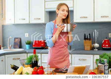 Attractive young blonde woman checking cooked food 106367557