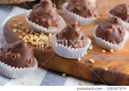 Small chocolate sweets with nuts close up 106367874