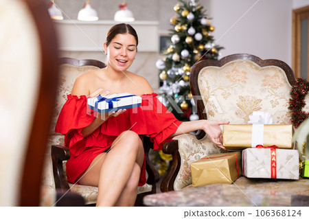 prepearing for New Year and preparing surprises, girl picked up most beautiful gift prepearing for New Year and preparing surprises, girl picked up most beautiful gift 106368124
