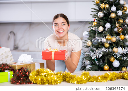 prepearing for New Year and preparing surprises, girl picked up most beautiful gift prepearing for New Year and preparing surprises, girl picked up most beautiful gift 106368174