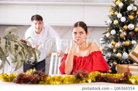 Couple quarreling - husband expresses displeasure to wife during new year celebration Couple quarreling - husband expresses displeasure to wife during new year celebration 106368354