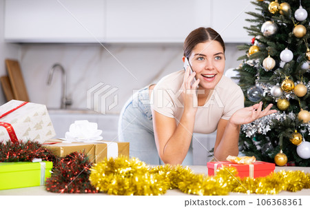 Talking on phone, girl shares plans for New Year 106368361