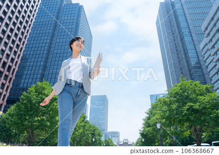 Young business woman in office casual working in the office district Young business woman in office casual working in the office district 106368667