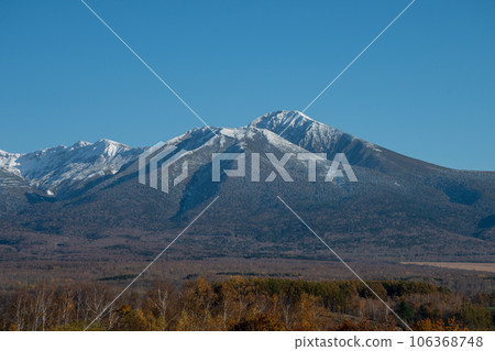 First snow mountain range and autumn forest 106368748
