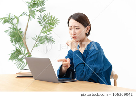 A woman troubled in front of a personal computer A woman troubled in front of a personal computer 106369041