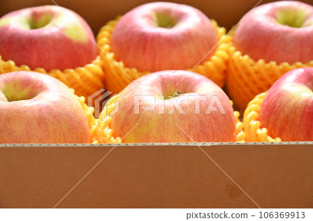 beautiful pink apple in yellow wrap bubble, healthy fruit in the box 106369913