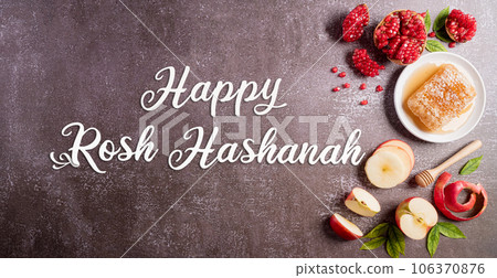 Rosh hashanah (Jewish New Year holiday), Concept of traditional or religion symbols on dark stone background. Rosh hashanah (Jewish New Year holiday), Concept of traditional or religion symbols on dark stone background. 106370876