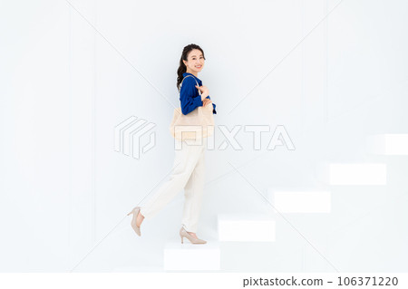 A young woman standing up the stairs A young woman standing up the stairs 106371220