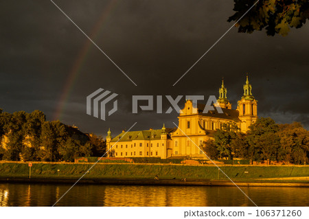 Heavy rain and rainbow above the Vistula river in Krakow Poland. Stunning views of the city rainy season and rainbow 106371260