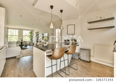 a kitchen and dining area in a home with hardwood flooring, white walls and wood floors the room is well lit a kitchen and dining area in a home with hardwood flooring, white walls and wood floors the room is well lit 106371343