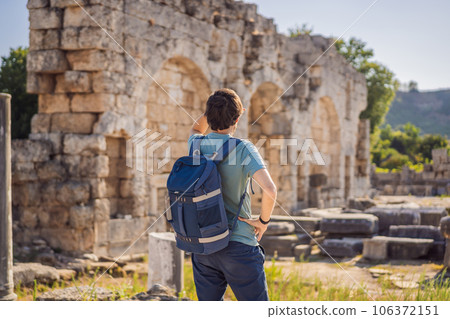 Tourist man at the ruins of ancient city of Perge near Antalya Turkey Tourist man at the ruins of ancient city of Perge near Antalya Turkey 106372151