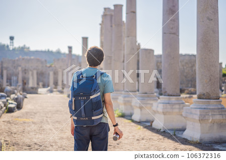 Tourist man at the ruins of ancient city of Perge near Antalya Turkey Tourist man at the ruins of ancient city of Perge near Antalya Turkey 106372316