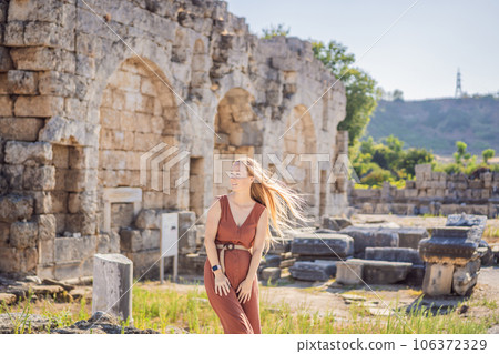 Pretty tourist woman at the ruins of ancient city of Perge near Antalya Turkey Pretty tourist woman at the ruins of ancient city of Perge near Antalya Turkey 106372329