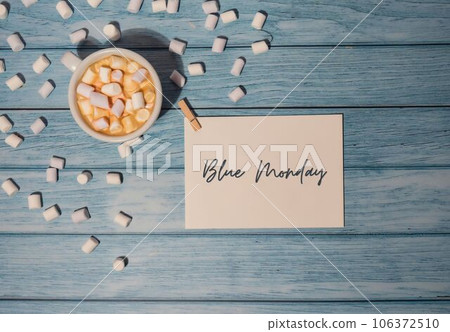 BLUE MONDAY concept text paper note with white cup of coffee and marshmallows on wooden background. The most depressing day of the year in January. Day commit suicide and depression BLUE MONDAY concept text paper note with white cup of coffee and marshmallows on wooden background. The most depressing day of the year in January. Day commit suicide and depression 106372510