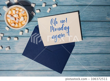 OH NO MONDAY AGAIN concept text blue envelope with white cup of coffee and marshmallows on wooden background. The most depressing day of the year in January. Day commit suicide and depression OH NO MONDAY AGAIN concept text blue envelope with white cup of coffee and marshmallows on wooden background. The most depressing day of the year in January. Day commit suicide and depression 106372511