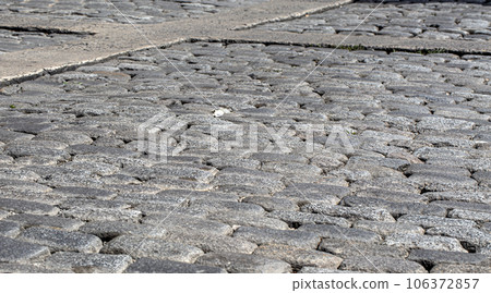 Old gray stone pavement texture. Old gray stone pavement texture. 106372857