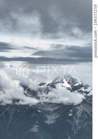 Gray mountain vertical landscape com clouds 106373259
