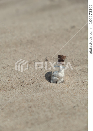 Souvenir Glass bottle with Sea shell. Seashell in glass bottle with seashells on the seashore sandy beach. Ocean seashell. Summer Memories from vacation Souvenir Glass bottle with Sea shell. Seashell in glass bottle with seashells on the seashore sandy beach. Ocean seashell. Summer Memories from vacation 106373302