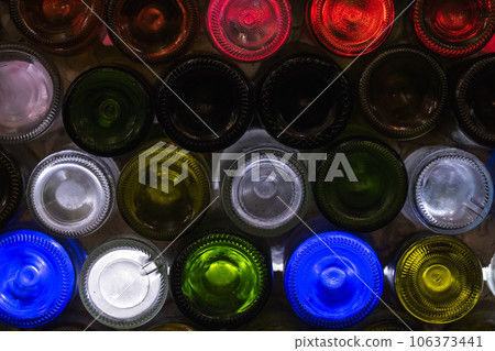 Decorative bar panel made of empty colorful wine bottles 106373441