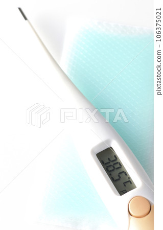 Photograph of the thermometer and cooling sheet against a white background Photograph of the thermometer and cooling sheet against a white background 106375021