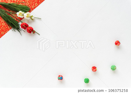 Plum blossoms and crepe balls on a red and white Japanese paper background Plum blossoms and crepe balls on a red and white Japanese paper background 106375258