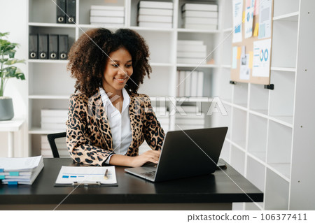 Business woman using tablet and laptop for doing math finance on an office desk, tax, report, accounting, statistics, and analytical research concept in office Business woman using tablet and laptop for doing math finance on an office desk, tax, report, accounting, statistics, and analytical research concept in office 106377411