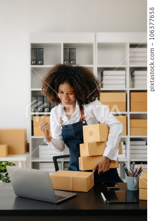 Small business entrepreneur SME freelance African woman working at home office, BOX,tablet and laptop online, marketing, packaging, delivery,  e-commerce concept 106377658