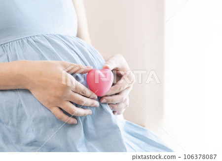 pregnant woman with heart pregnant woman with heart 106378087