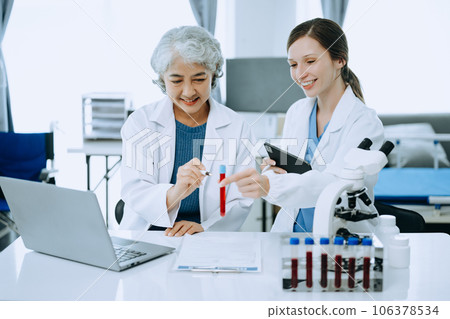 Scientist team meeting and writing analysis results in the laboratory study and analyze scientific sample, test samples Scientist team meeting and writing analysis results in the laboratory study and analyze scientific sample, test samples 106378534