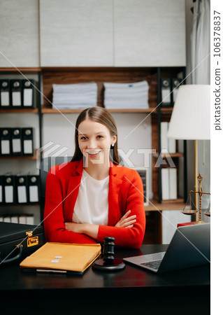 justice and law concept. Female judge in a courtroom the gavel, working with smart phone and laptop and digital tablet computer on black table justice and law concept. Female judge in a courtroom the gavel, working with smart phone and laptop and digital tablet computer on black table 106378837