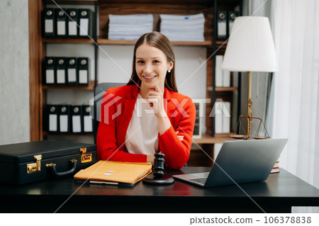 justice and law concept. Female judge in a courtroom the gavel, working with smart phone and laptop and digital tablet computer on black table justice and law concept. Female judge in a courtroom the gavel, working with smart phone and laptop and digital tablet computer on black table 106378838